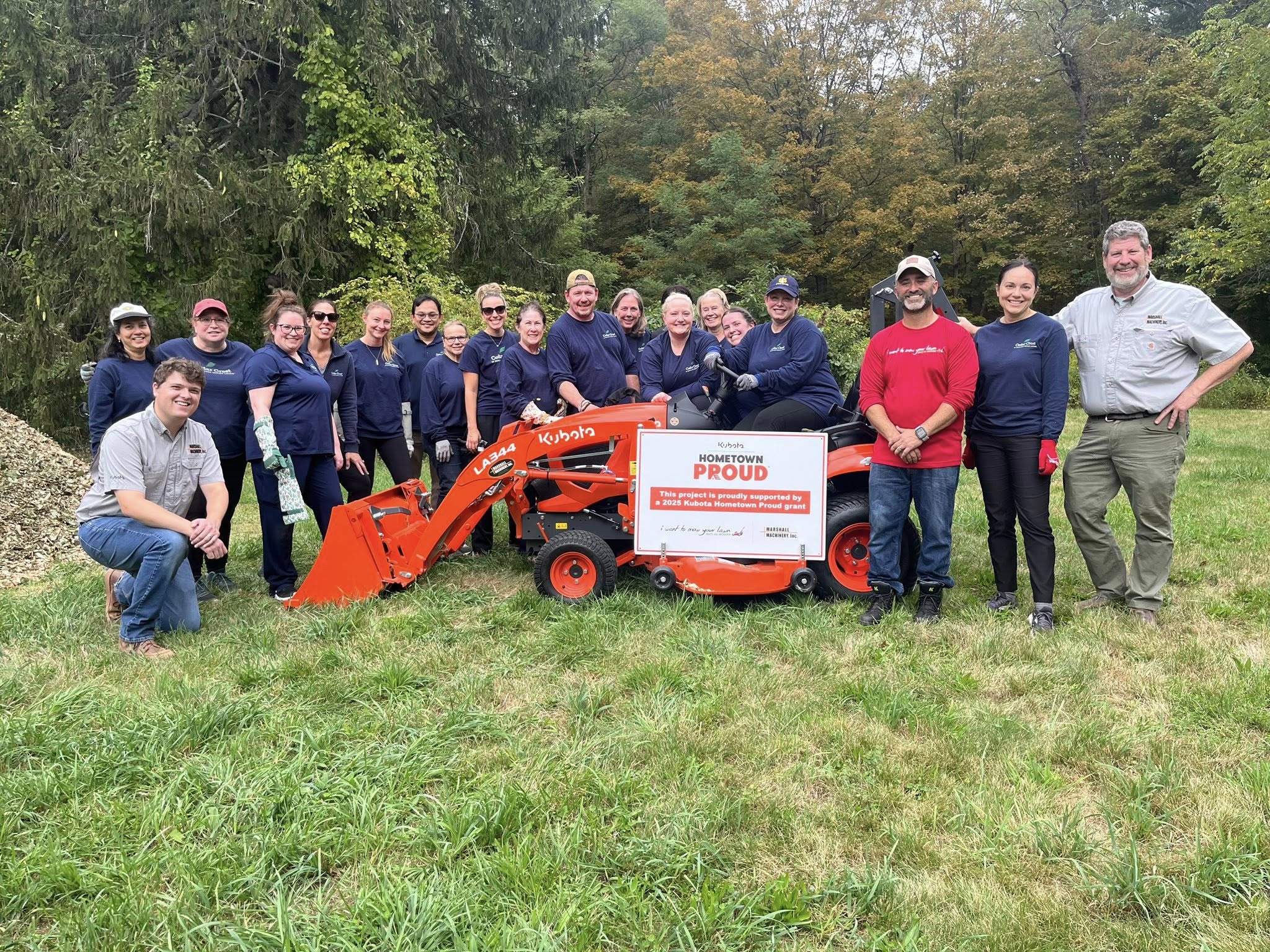 Cedar Crest Senior Living group volunteers with equipment and signage during a National Rehab Week Service Day coordinated by I Want To Mow Your Lawn