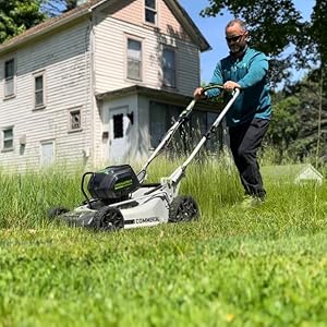 Brian mowing an overgrown yard for a homeowner in need