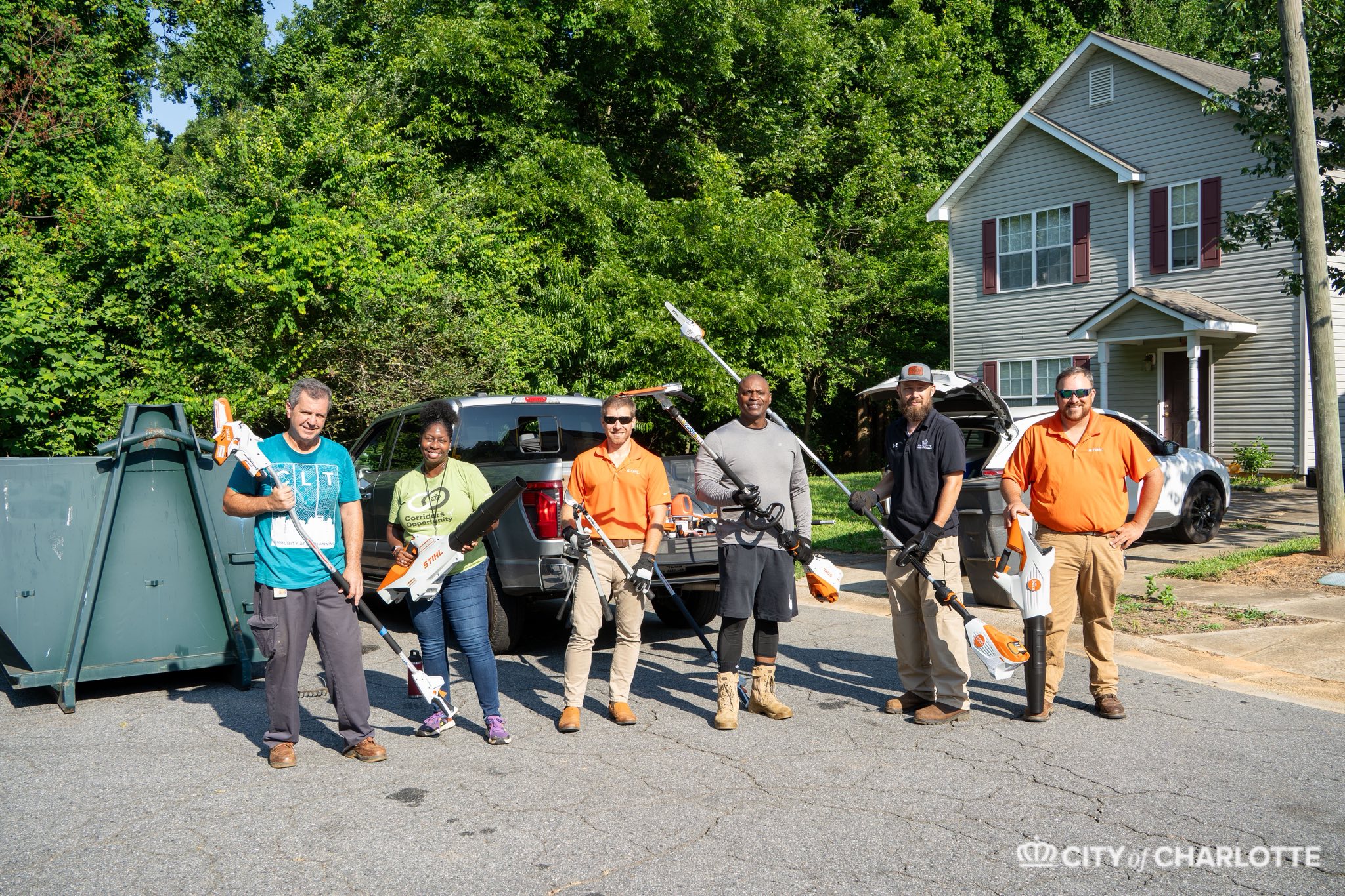 STIHL representatives and Charlotte community partners standing together during a service day in Hidden Valley.