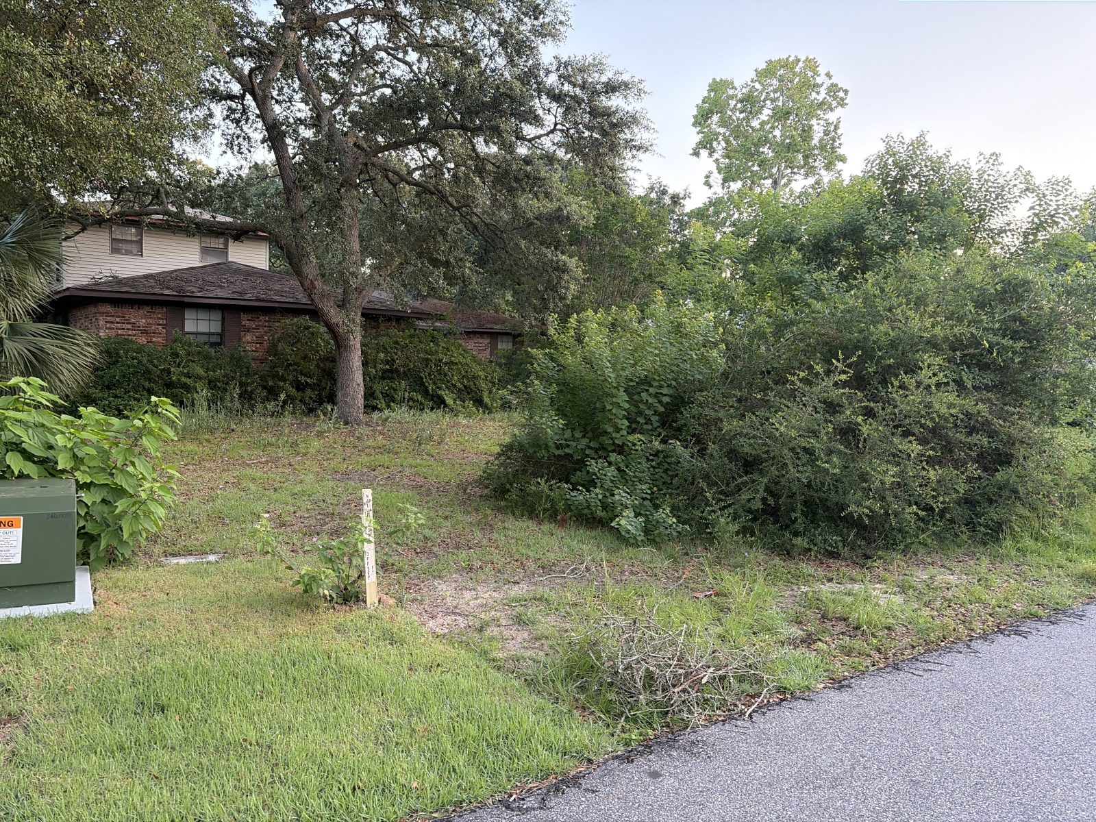 Privacy-protected yard photo submitted through Mow Notice in Gulf Shores, AL